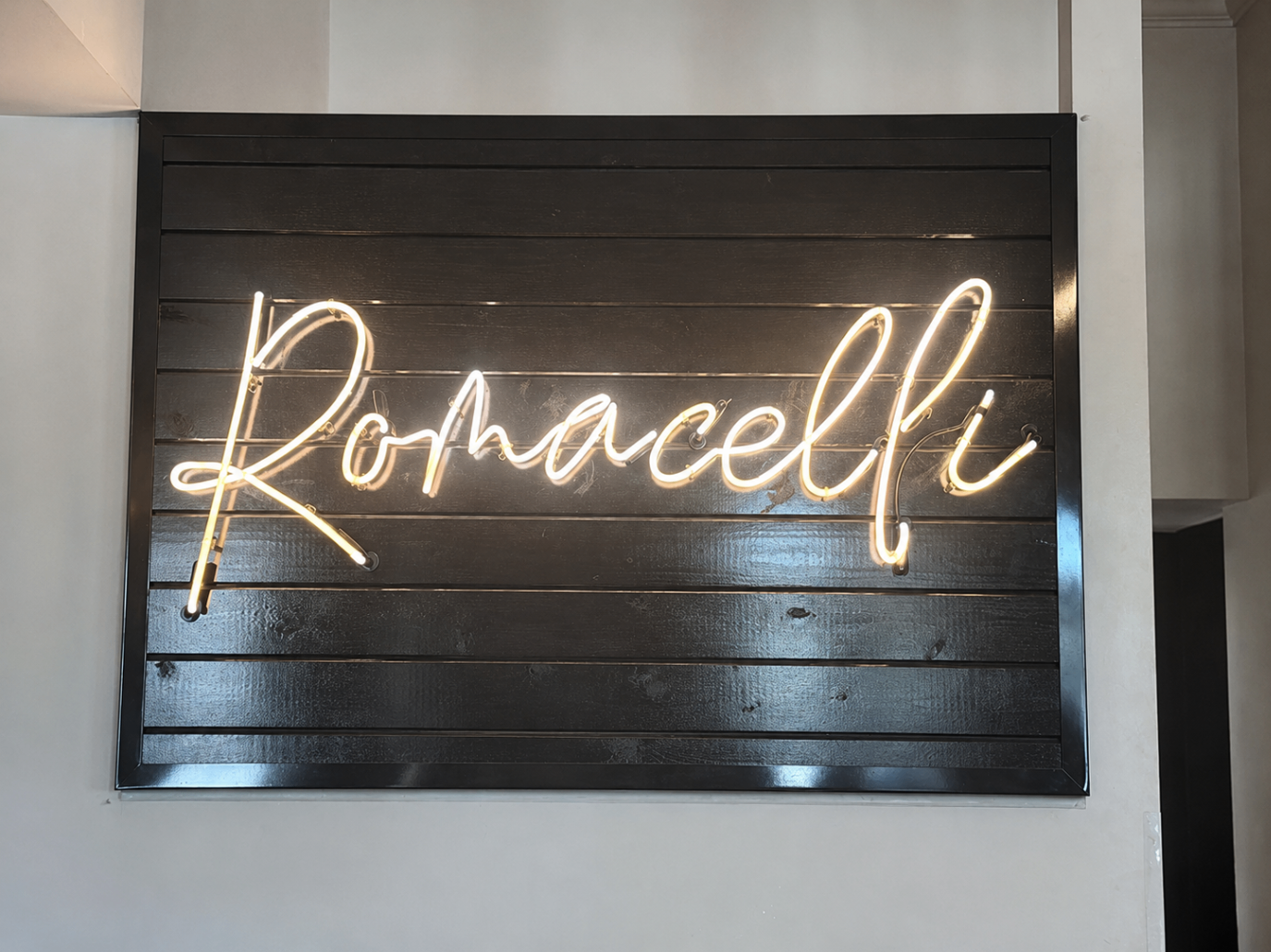 Romacelli neon sign inside the restaurant in Lafayette, LA