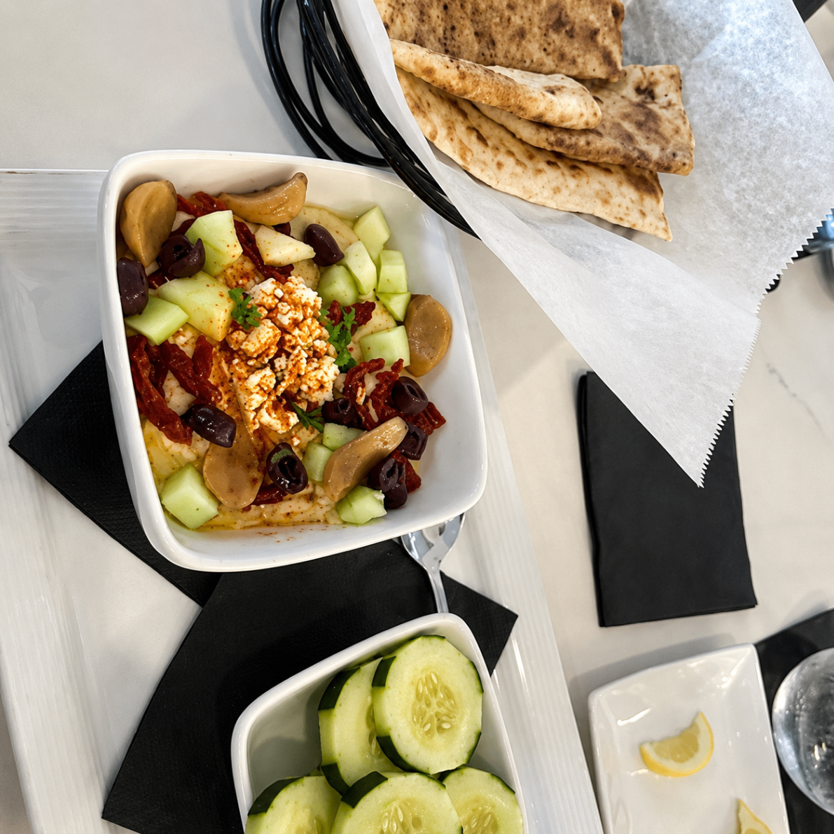 Mediterranean hummus with feta, olives, and warm pita at Romacelli